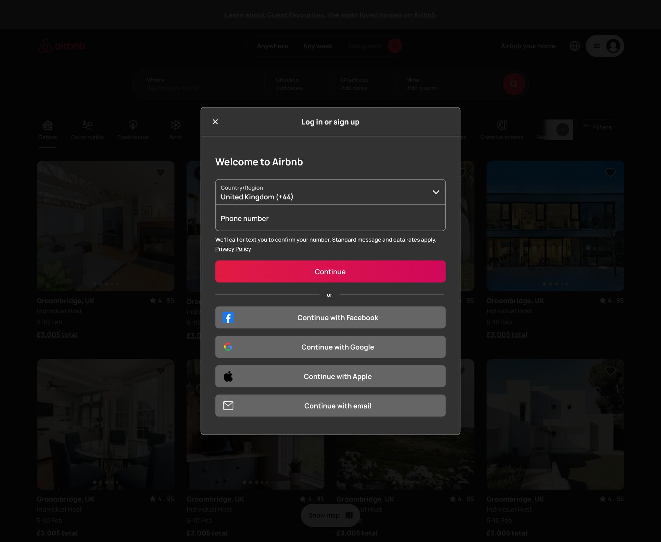 Dark mode: desktop log in or sign up modal: country, phone, continue and social options.