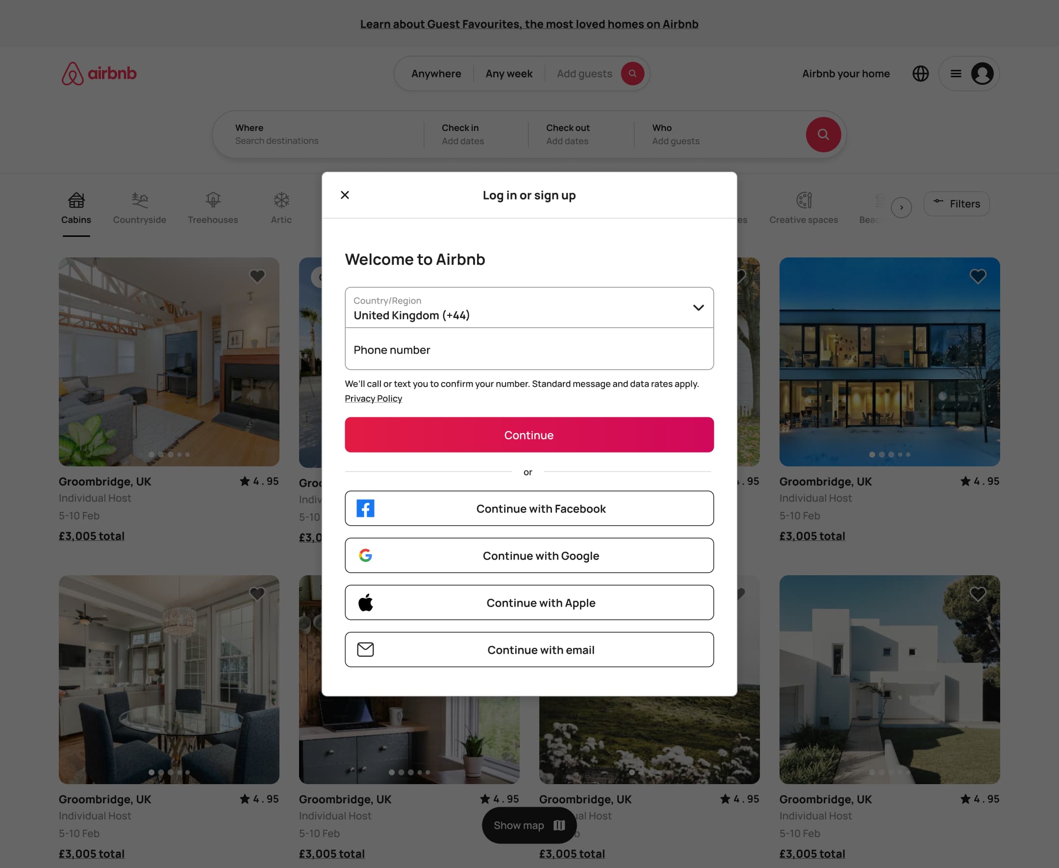 Desktop log in or sign up modal: country, phone, continue and social options.