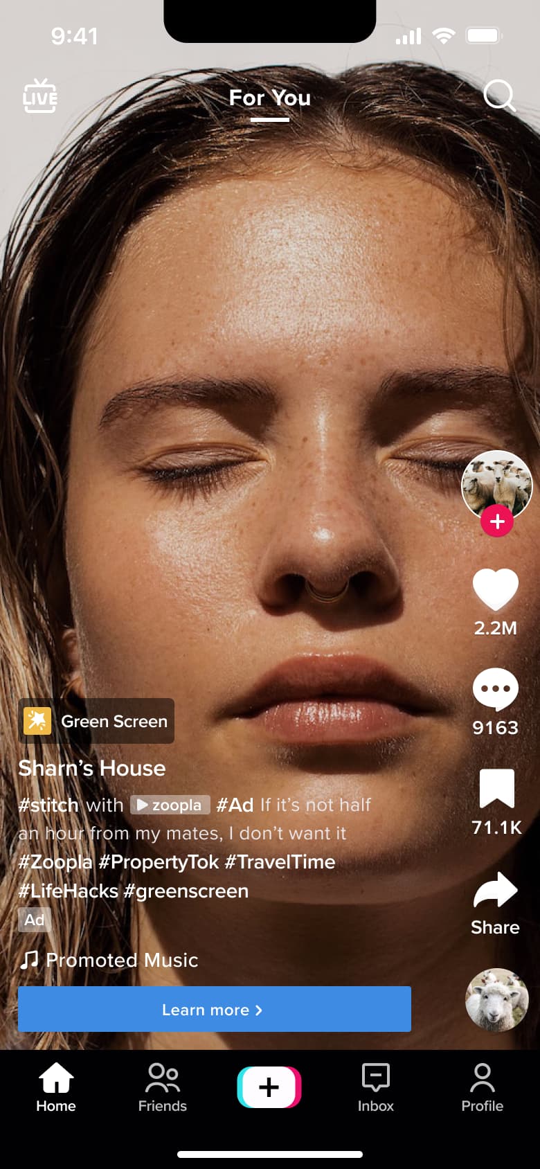 Sponsored feed video with learn more button and promoted music label.
