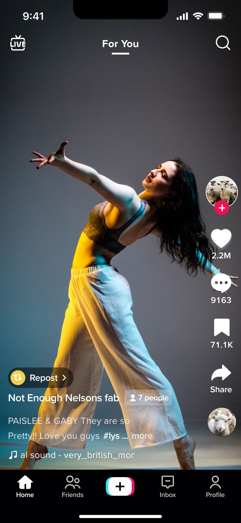Feed video with repost chip, group badge and caption.